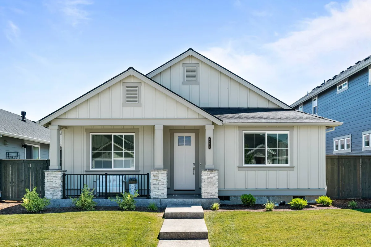 A charming view of the home’s front porch and main entrance, surrounded by a neatly landscaped yard. The porch invites moments of relaxation and sets the stage for transitioning from home to the community beyond.